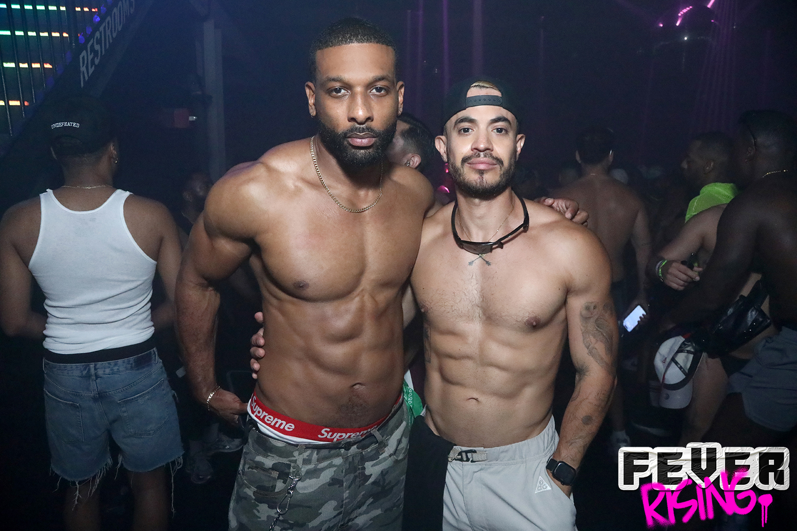 Two guests posing on the packed dance floor