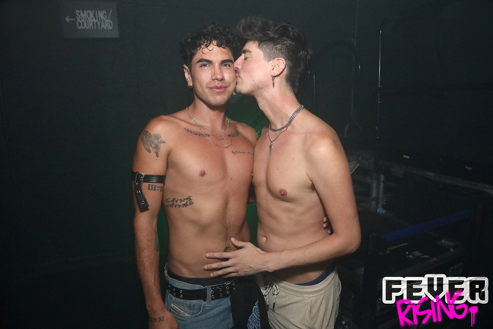 Two guests sharing a kiss near the smoking courtyard