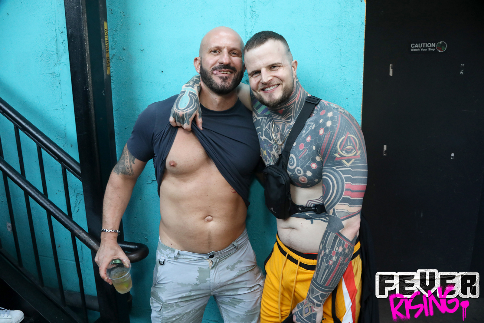Two tattooed guests in the stairwell